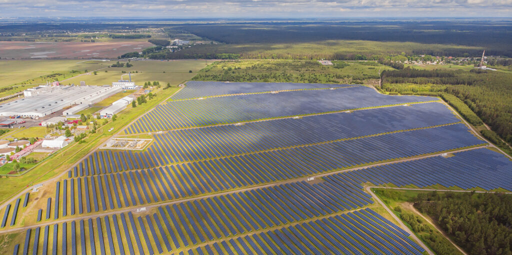 Solar Power Plant In The Field. Aerial View Of Solar Panels.